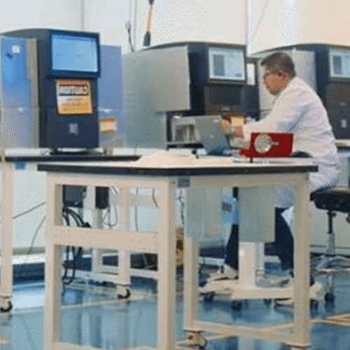 Scientist sitting at a desk with a row of AVITIs